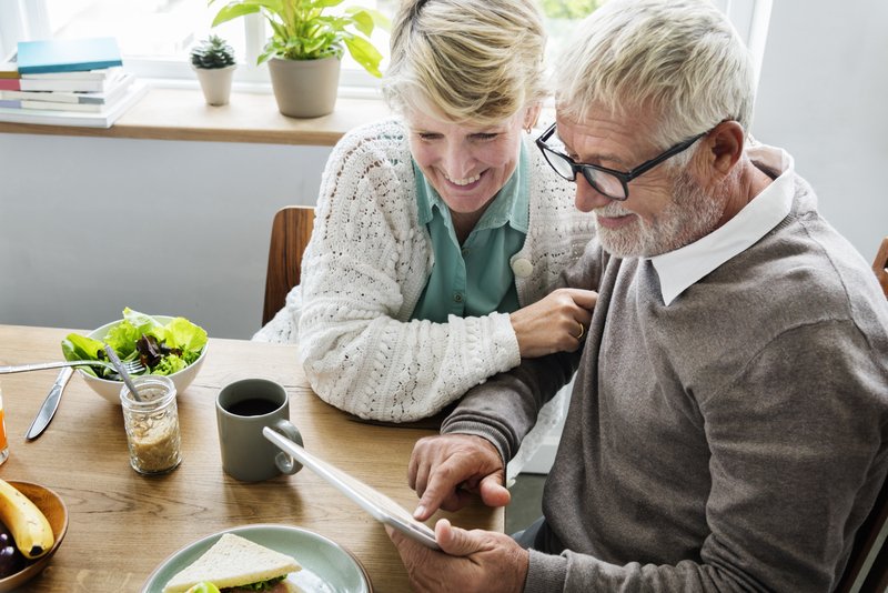 senior couple looking at tablet - top certified financial planners in connecticut