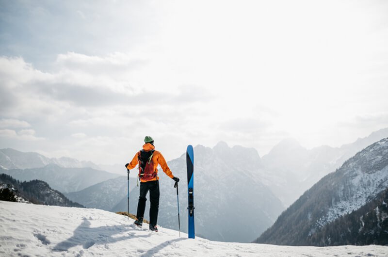 skier top of mountain looking - we provide insurance planning services farmington ct